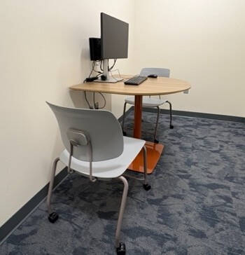 ASH 1207, the individual testing room with a computer on a desk and two chairs